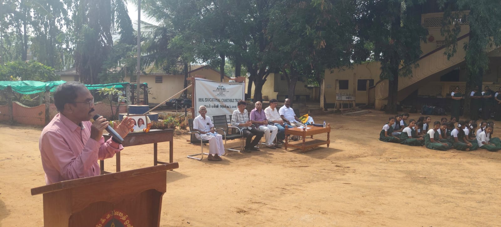 A trustee addresses NSKP students on the school ground